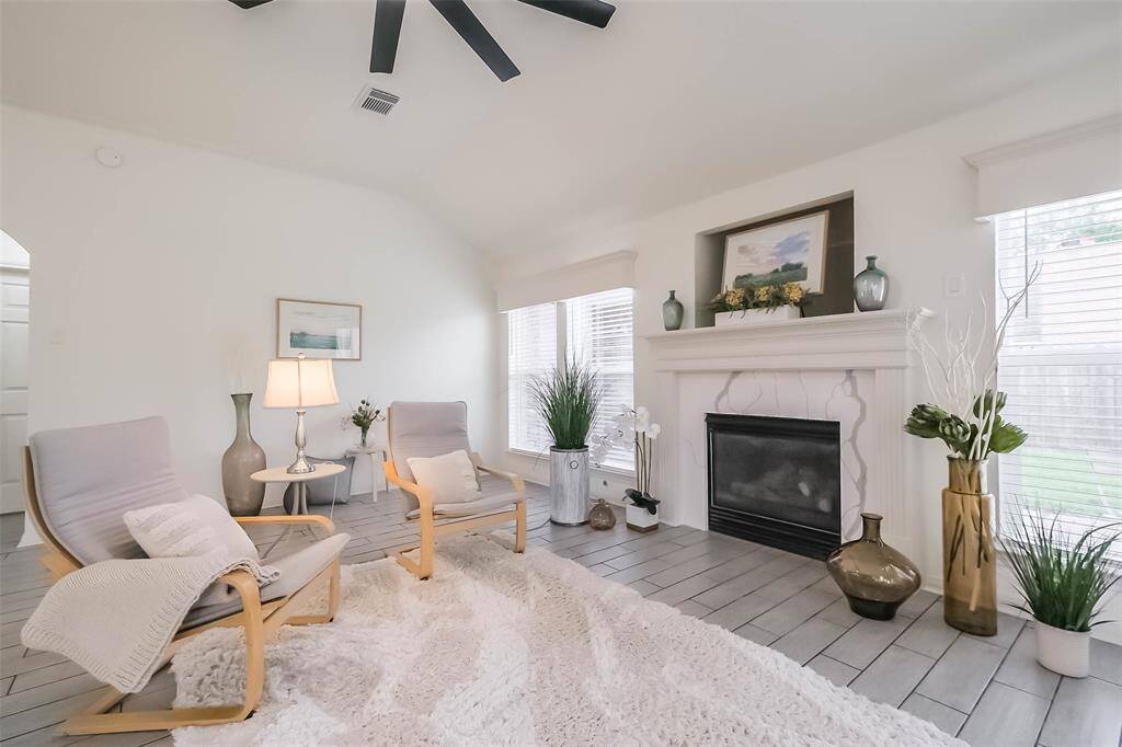 Spacious family room has huge, new, 66" smart ceiling fan with remote. Nook over fireplace can be place for your TV as well as the wall on the left which has plug in the wall. New quartz fireplace surround. Gaslog fireplace. Door on right leads to patio and garage.