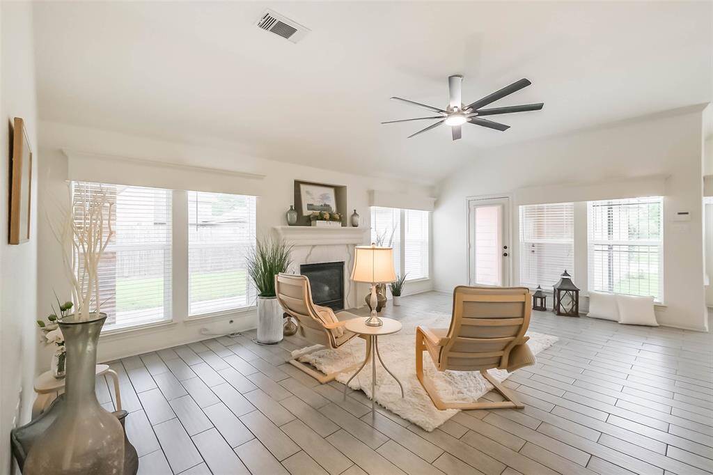 View in family room back towards the entry foyer and front door. This gorgeous airy and bright home is ready for move in. Arched doorway to the right leads to the primary suite.