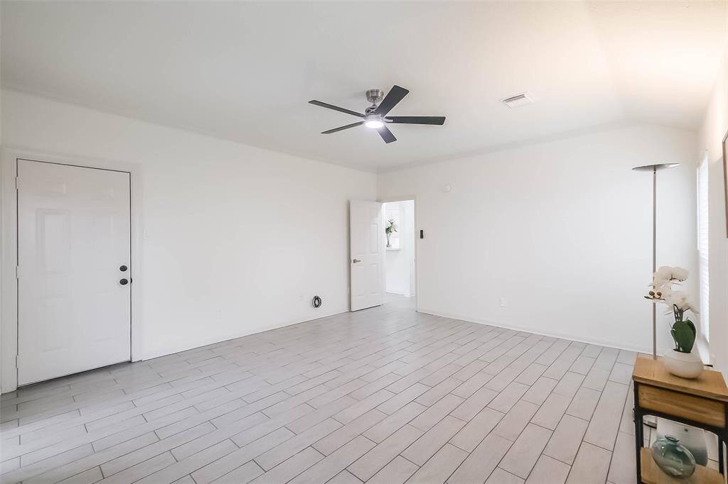 Walking to the primary suite and looking back at the family room