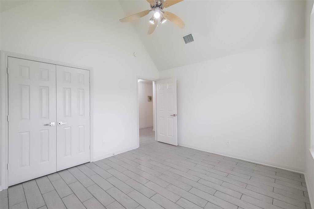 The front secondary bedroom has high ceilings and a large window seat and a bay window.