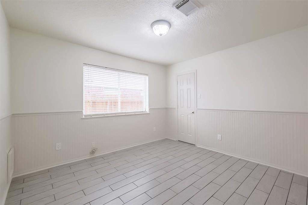 Last secondary bedroom with beadboard wainscoting.