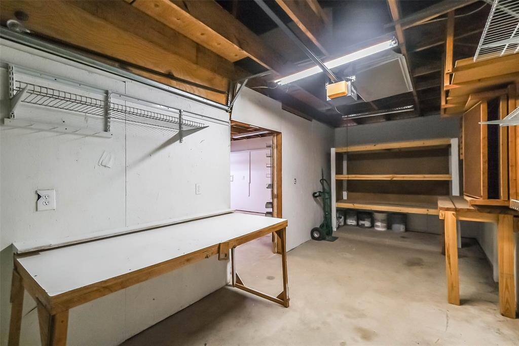 Freshly painted garage with wall constructed to create workshop space. If a workshop space wasn't desired, the wall can be removed.