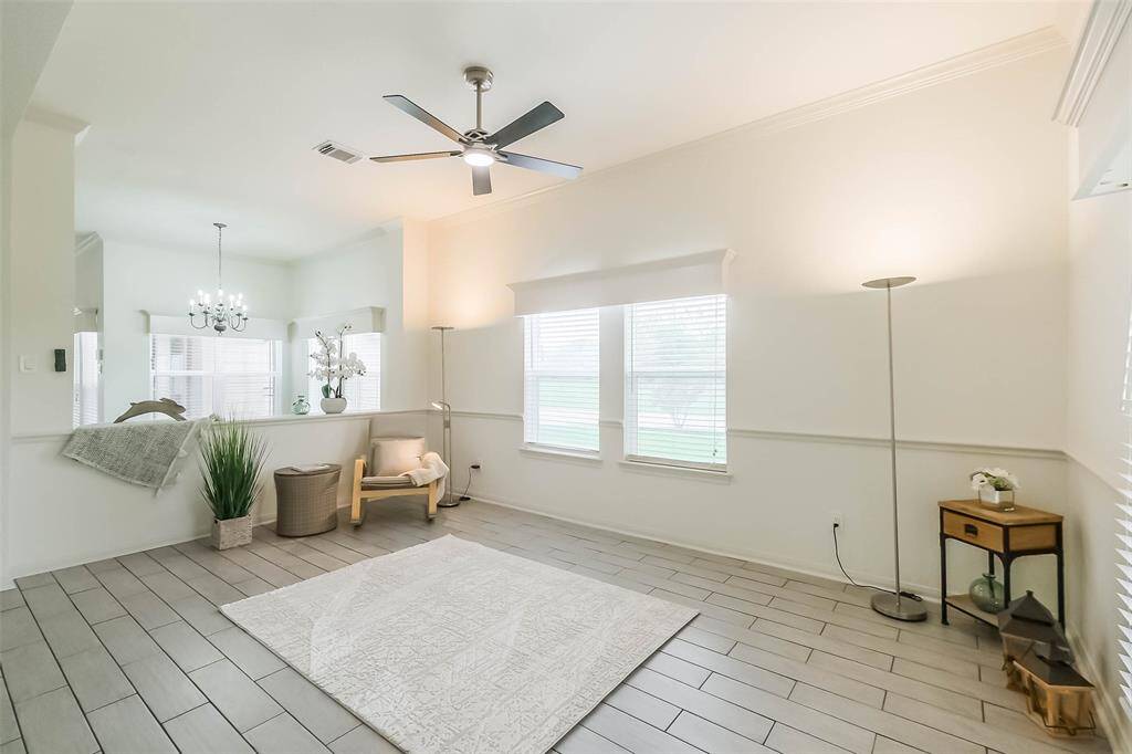 Front living room, with high ceilings and crown molding has a new LED ceiling fan with color changing lights and remote control. Lots of light through the new double paned windows.