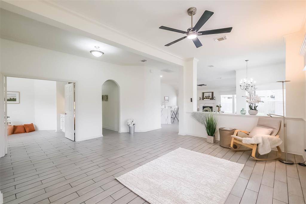 All the windows have hard box wood valances. Half wall separating front living room from dining room.