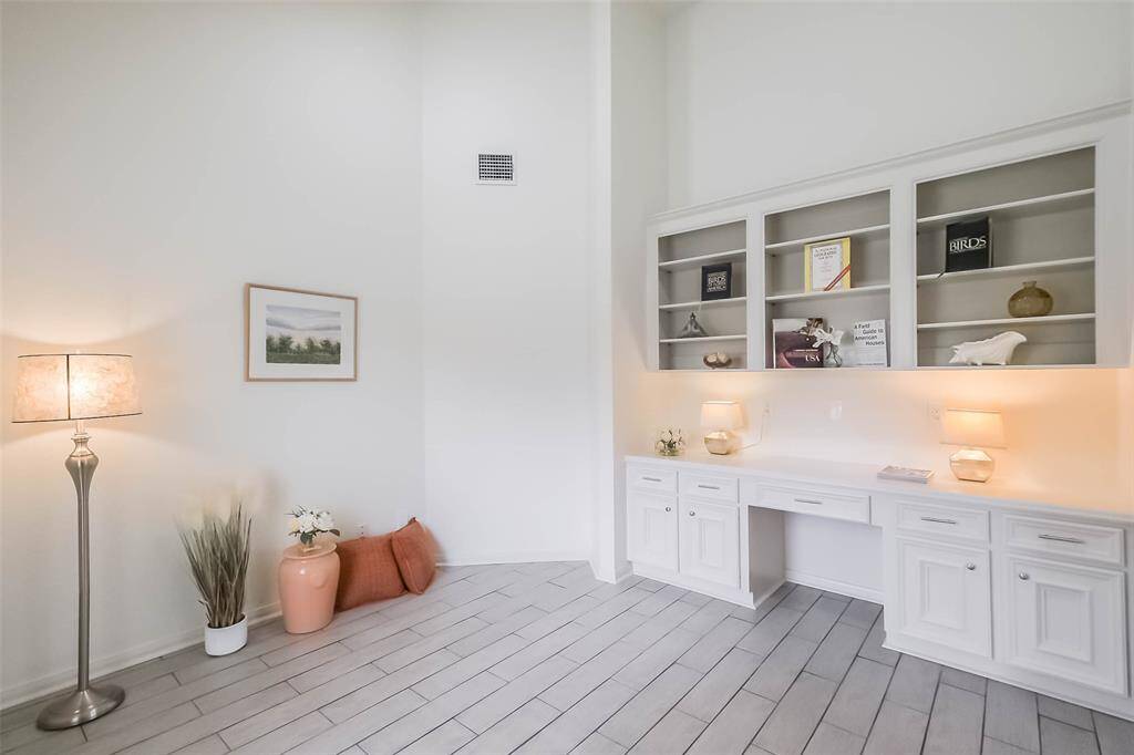 On the other side of the foyer is the lovely home office with high ceilings and lots of light.