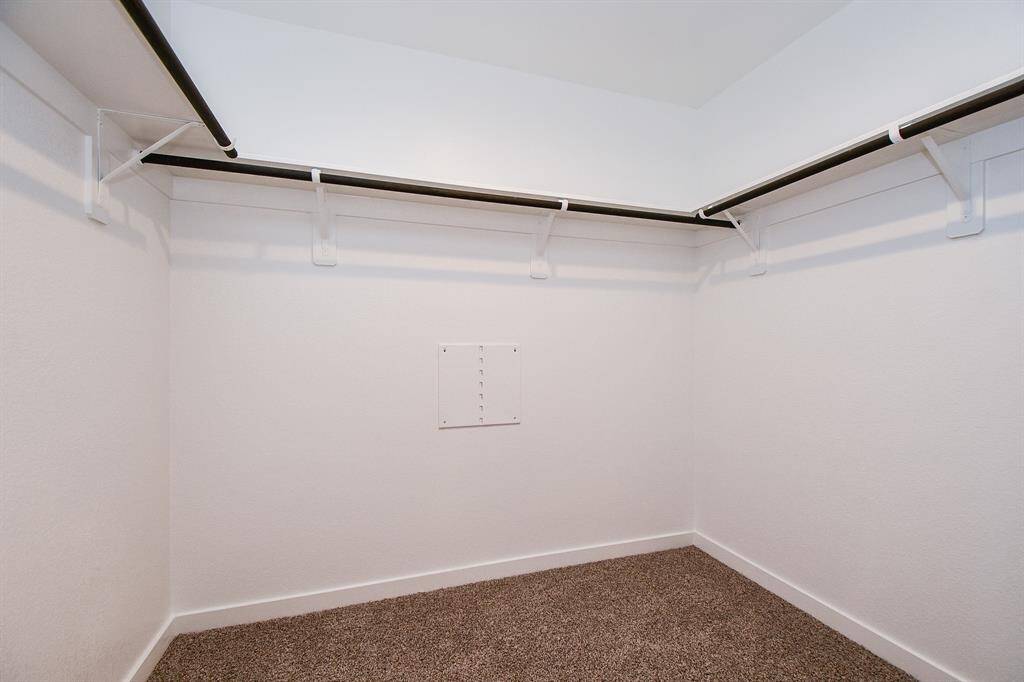 Primary bedroom walk in closet