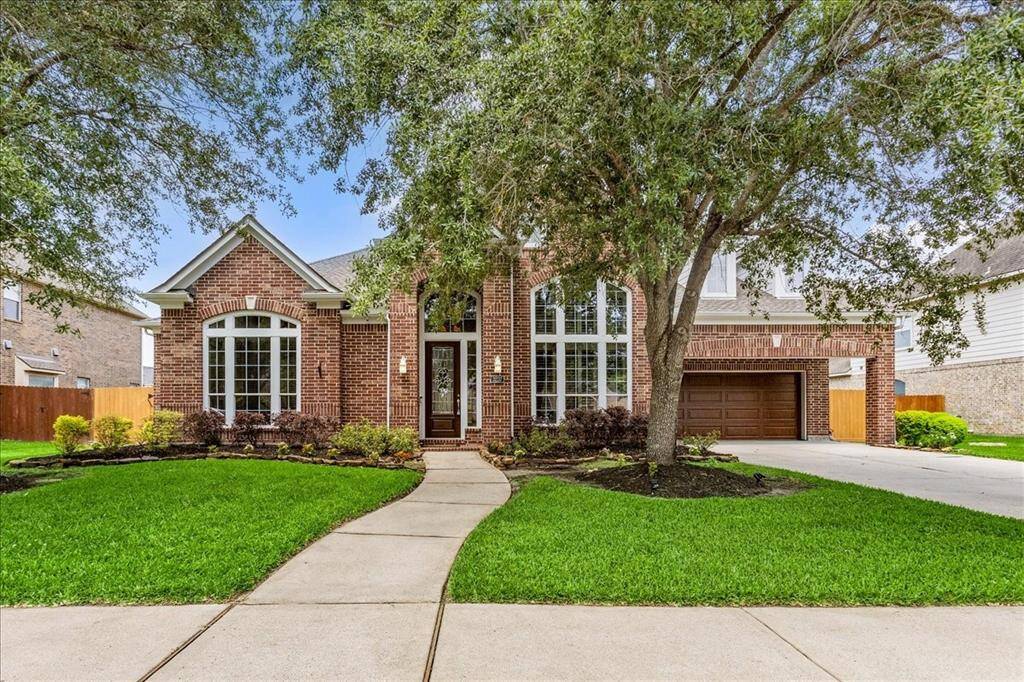 What a beautiful home with tons of curb appeal! Professionally landscaped, sprinkler system and a new roof and fence!