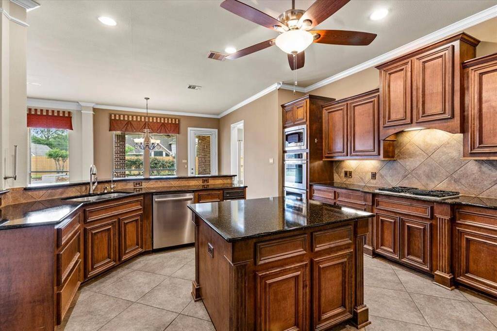 Under counter lighting, trash compactor, granite counters, double oven, real wood cabinets and so much more!