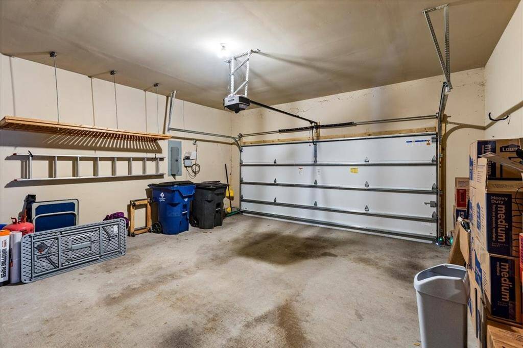 There is plenty of space and extra storage in this three-car garage. New super-quiet smart technology garage door opener and insulated garage door.
