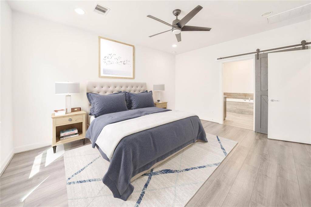 This virtually staged primary bedroom, complete with an en suite primary bathroom, is both bright and spacious. The open layout offers plenty of room to relax and unwind, while the attached bathroom provides a private, luxurious retreat with all the modern touches.