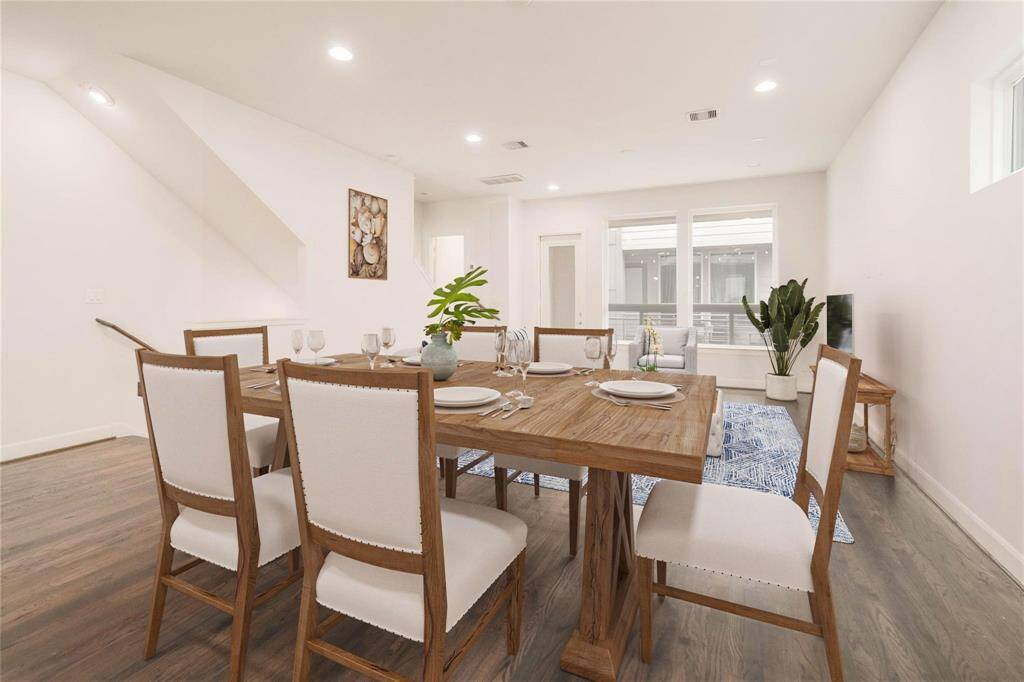 In this virtually staged photo, you can envision how a dining area seamlessly fits into the expansive living room, all while staying conveniently close to the kitchen for easy entertaining and daily living.