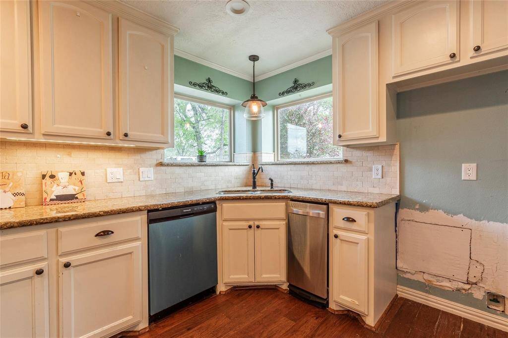 Kitchen sink perfectly situated in the corner with plenty of natural light from the windows
