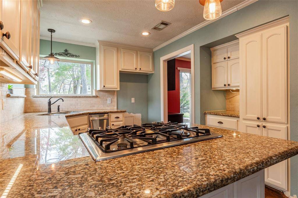 The heart of the home features sleek granite countertops, adding both durability and elegance to this stunning kitchen.
