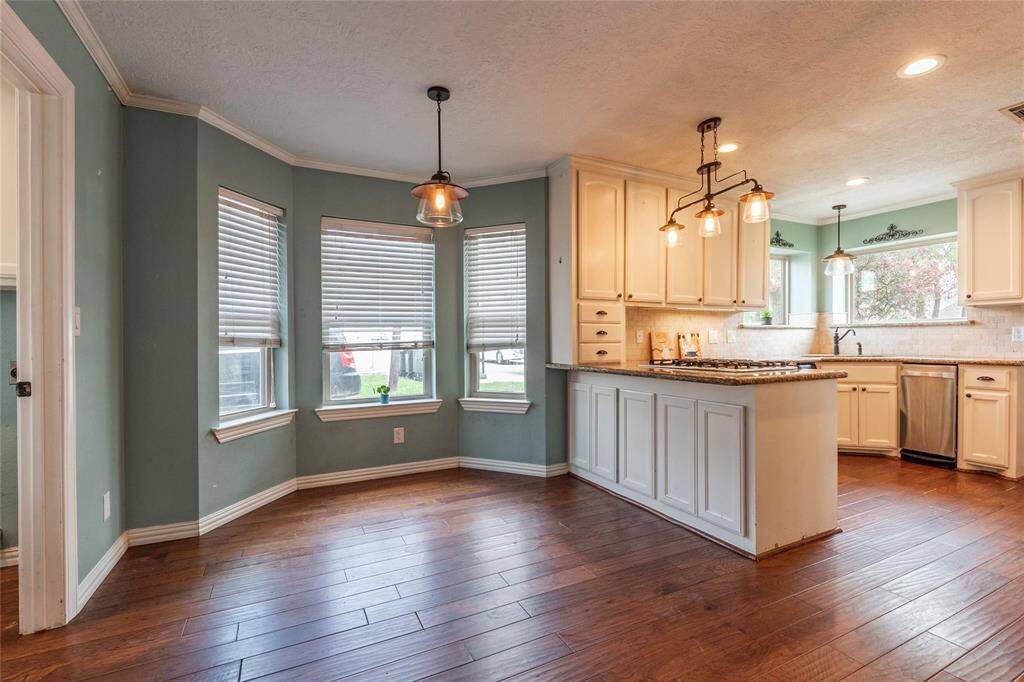 Just off the kitchen, this charming breakfast nook offers the perfect spot to start your day, with plenty of natural light and easy access to the heart of the home.