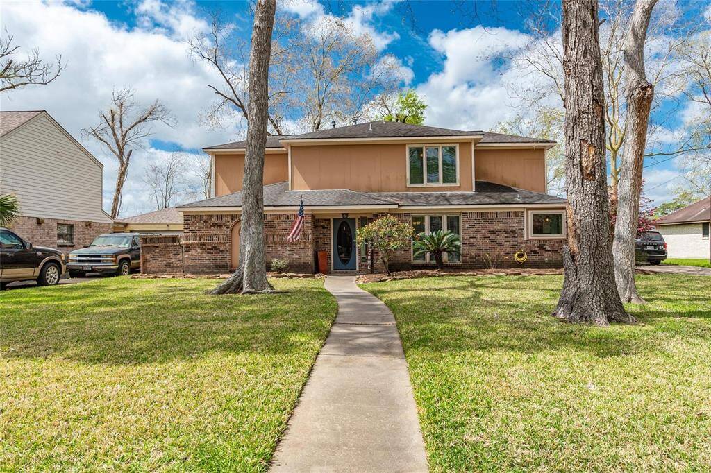 Enjoy the beauty of a huge front yard, adorned with towering trees that provide both privacy and a picturesque backdrop for this stunning property.