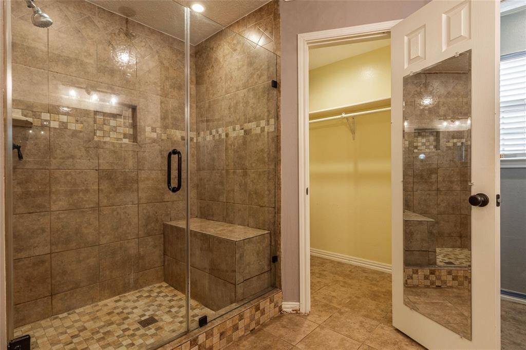 Walk in Shower situated between 2 walk in closets