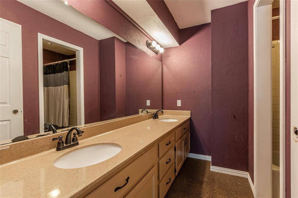 Full Bath situated between the secondary bedrooms offers a dual vanity and a tub/shower combo