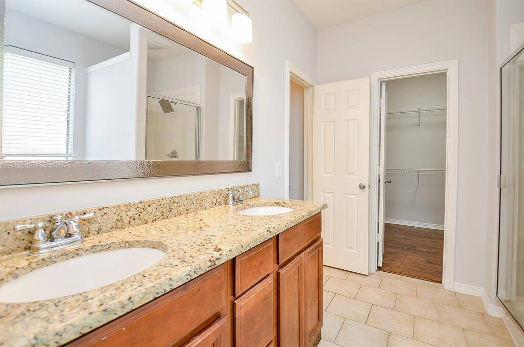 MASTER BATH --GRANITE VANITY TOP WITH DUAL SINKS, NEWLY REPLACED MIRROR, LIGHTING FIXTURE, NEW TOILET AND NEW SHOWER HEAD )