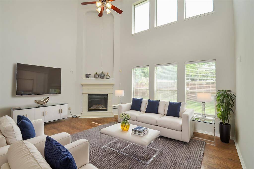 TWO STORY HIGH CEILING DEN WITH CORNER CASTSTONE FIREPLACE,