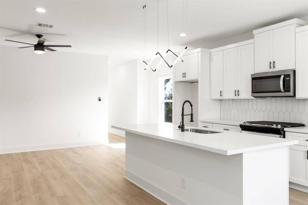 A modern pendant light adds a nice touch to the kitchen.