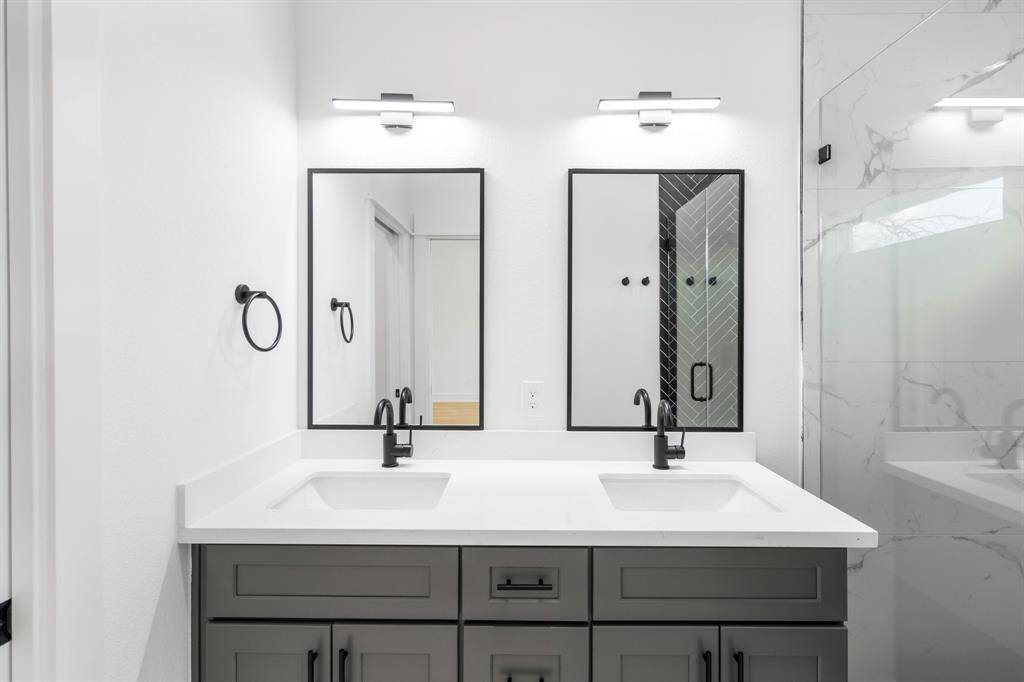 Contemporary finishes are found in the primary bathroom.