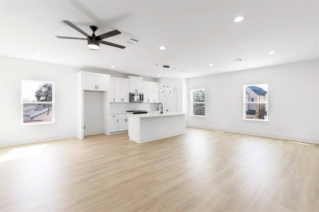 The open-concept living room and kitchen feels bright and airy.