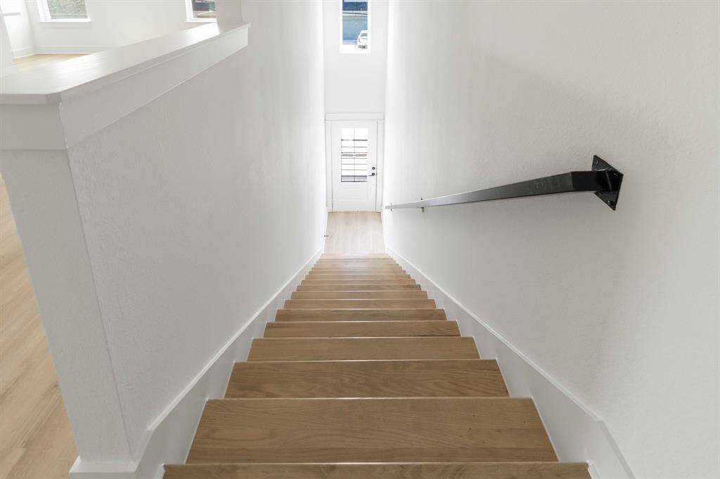 The front door leads directly to the stairs which bring you to your new home.