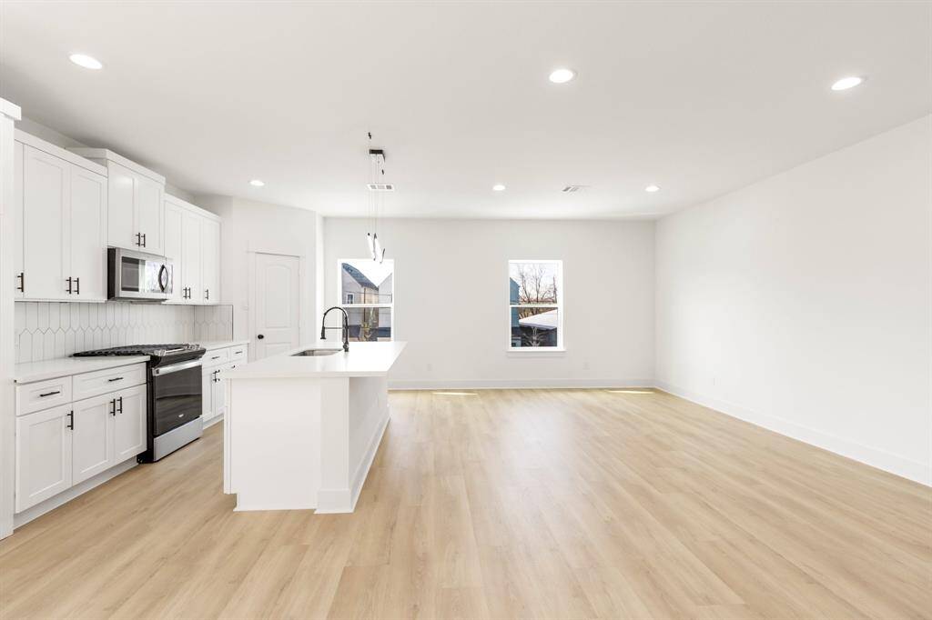 The spacious living room  features oversized windows.