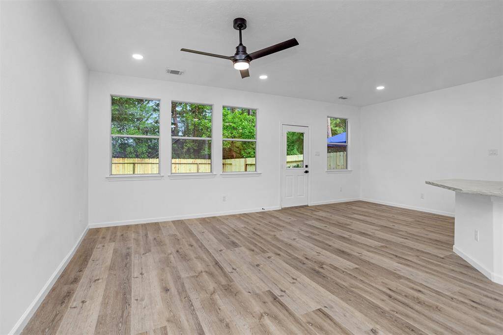 Spacious family room with tons of natural light and additional recessed lighting.