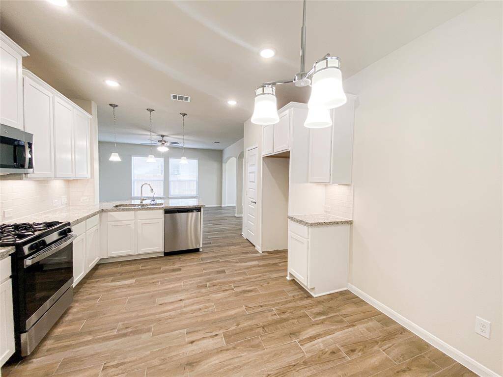 Kitchen has under the cabinet lights, 5-burner gas range and gas oven