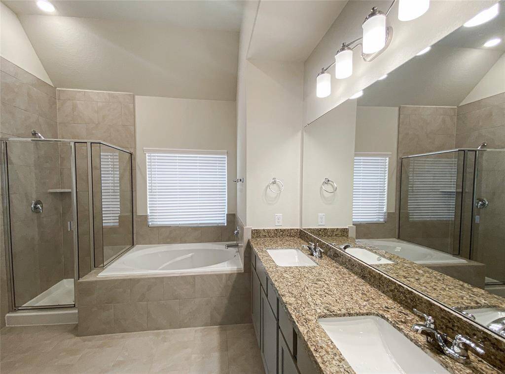 Raised granite countertops, double sinks and separate shower and tub in master bath