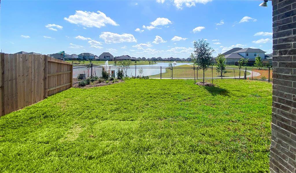 Wrought iron fence with gate to the walking trail around the lake. Don't miss the opportunity to live in this one-of-a-kind beautiful home. Call today for a tour!
