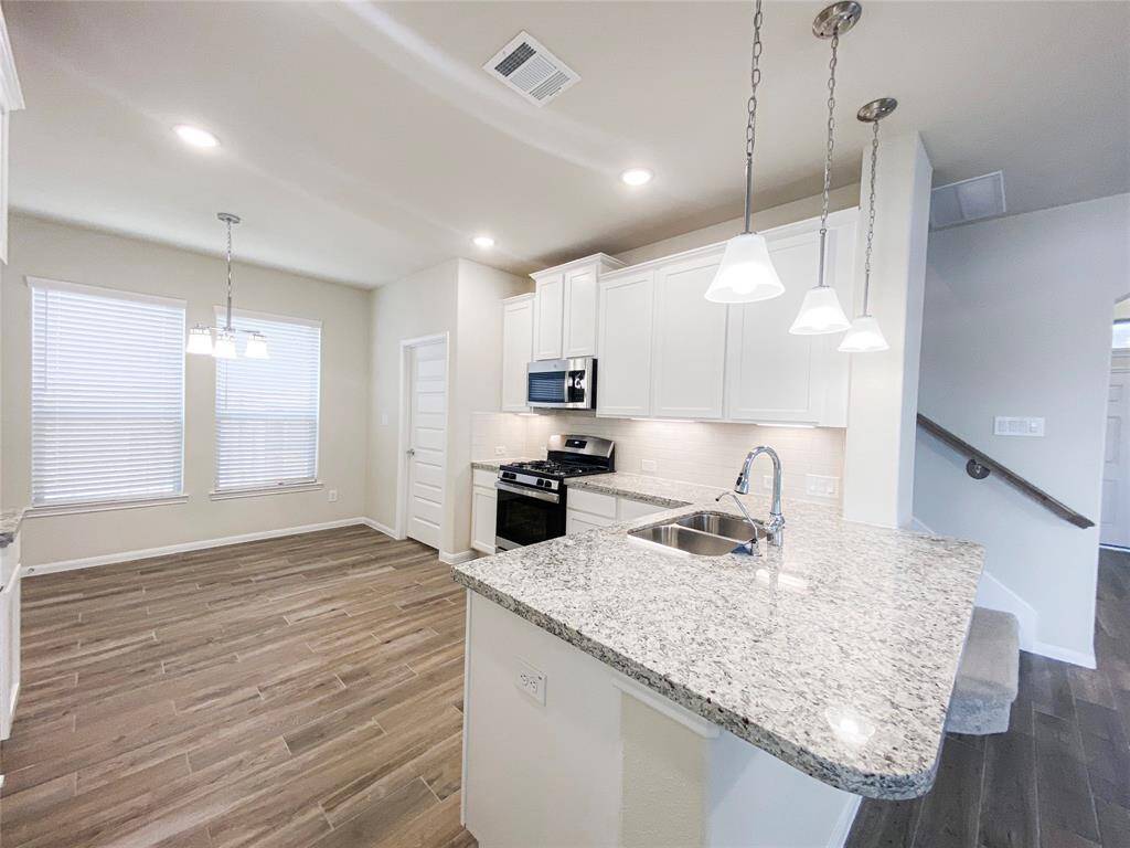 Kitchen with breakfast bar and pendant lights