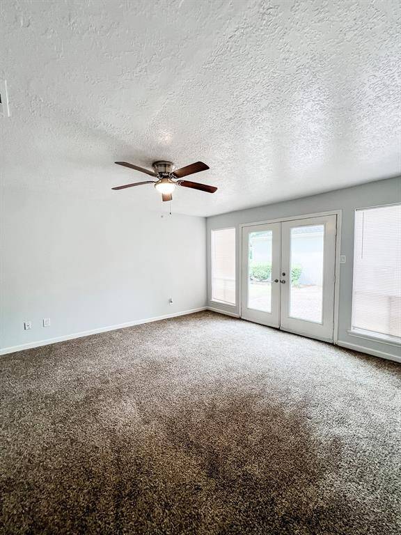 View of the main bedroom area with an entrance/exit to the back yard and garage.