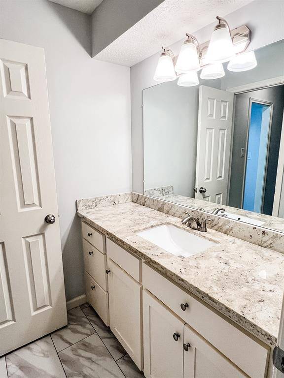 View of the secondary bathroom with double sinks. Two of the bedrooms lead to this secondary bathroom.