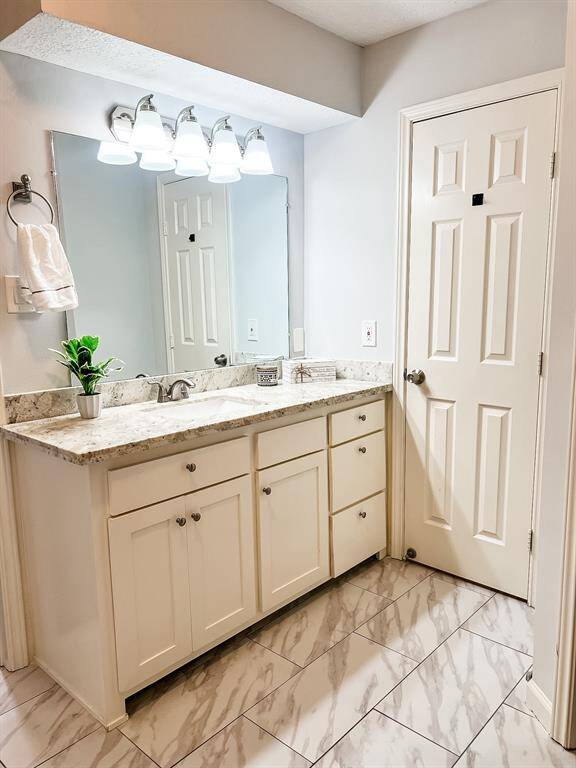 View of the main bathroom with beautiful granite countertops.