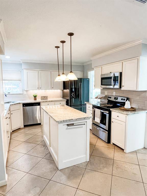 First view of the kitchen as you walk inside from the backdoor.