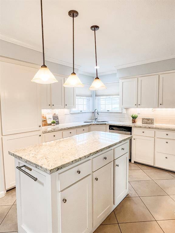 Alternate view of the kitchen with beautiful granite countertops and plenty of space to cook your delicious meals!