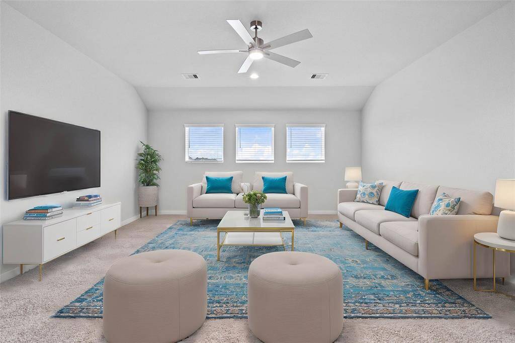 Come upstairs and enjoy a day of leisure in this fabulous game room! This is the perfect hangout spot or adult game room, this space features plush carpet, high vaulted ceiling, ceiling fan, recessed lighting, custom paint and large windows with privacy blinds.