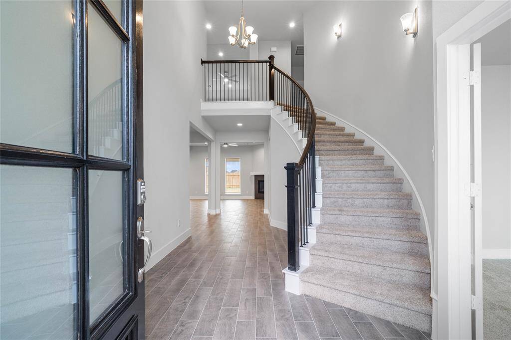 Welcome inside 461 Piney Rocks where you are greeted with this beautiful and bright space featuring the grand staircase, recessed lighting and gorgeous wood-look tile flooring!