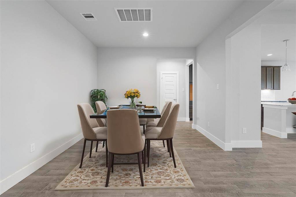 Make memories gathered around the table with your family and friends! This dining room features high ceilings, custom paint, and gorgeous flooring.