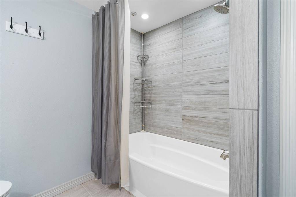 Tub shower in hall bath.