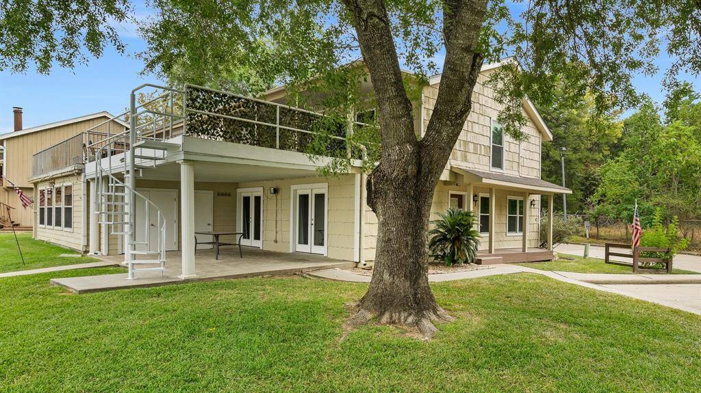 This duplex has a rare side yard, large covered patio down and partially covered balcony above with spiral access from outside. Note the storage closets below.