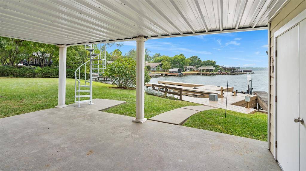 Covered porch and boat dock area! Two slips with lifts.