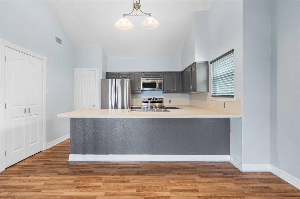 The kitchen has a spacious breakfast/ serving bar, stainless steel appliances and refrigerator that stays. The are two nice pantries so plenty of storage.