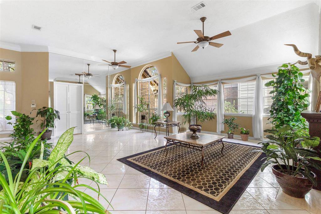 The dining area and family room are both bathed in naturallight streaming through expansivewindows.