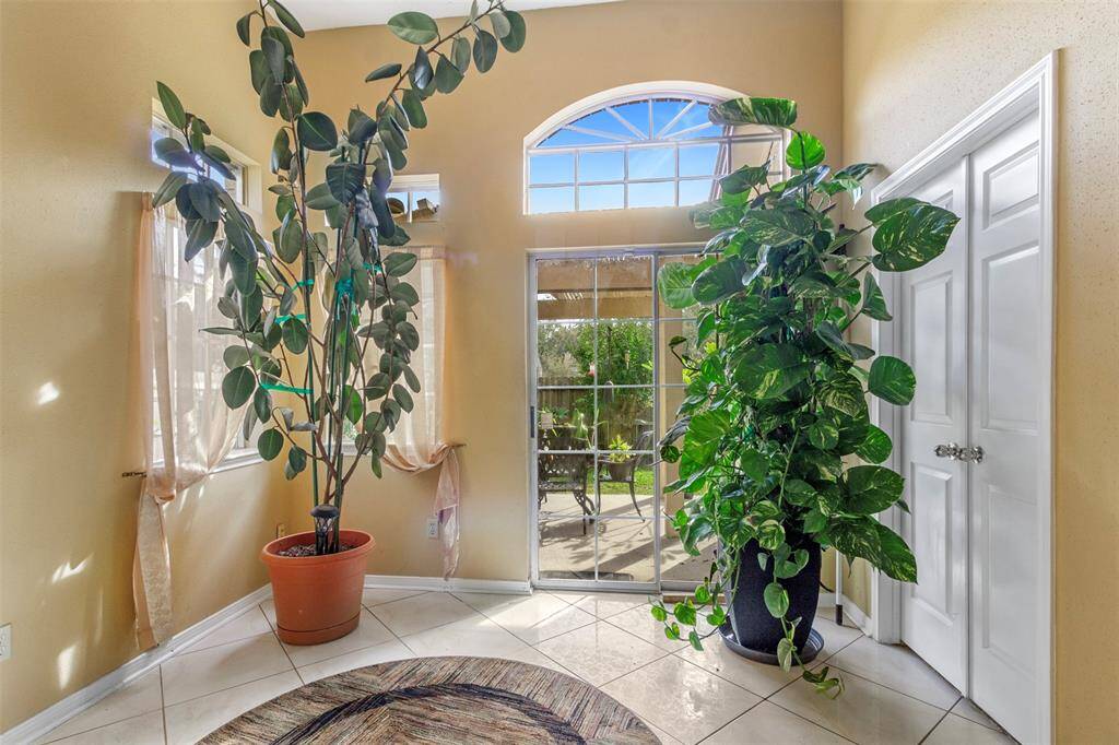 The home office features tile floors, custom paint, and large windows.