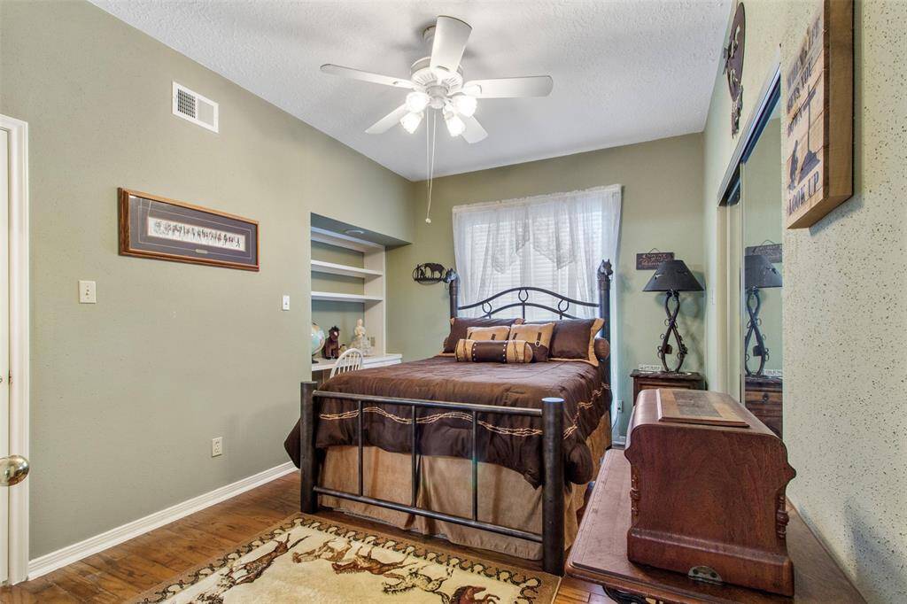 Secondary bedroom features awindow, custom paint, and ceiling fan.