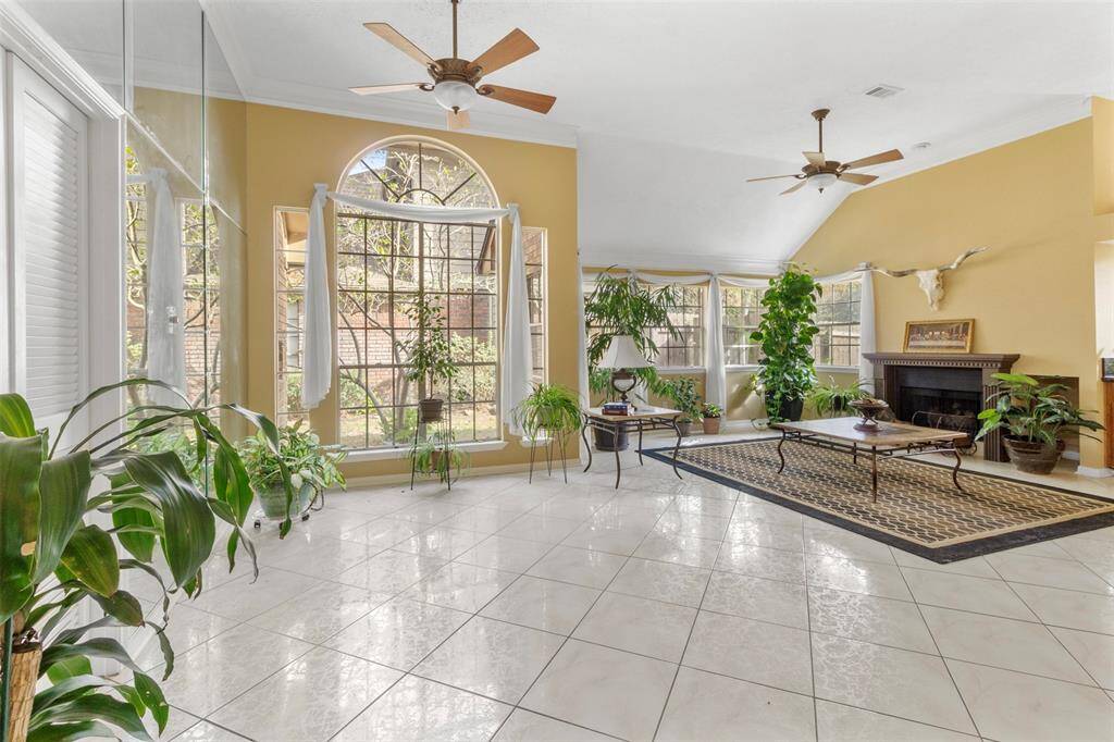 The entryway features tile floors, custom paint, high ceilings, and large windows.