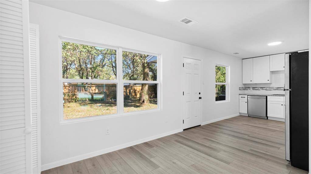 The dining area is open to the renovated kitchen with great view of the backyard